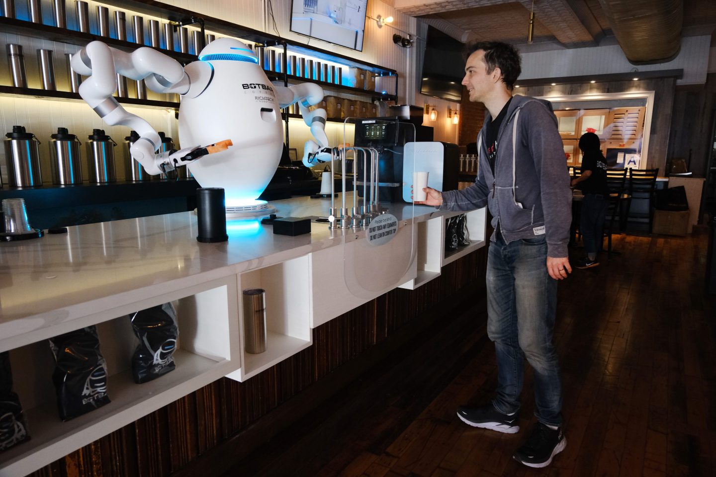 A two-armed robot called "ADAM" prepares a cup of coffee for a customer at Botbar coffee shop on May 31, 2023 in the Brooklyn borough of New York City.