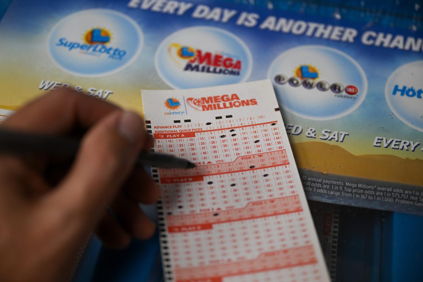 Close-up of a person choosing Mega Millions numbers