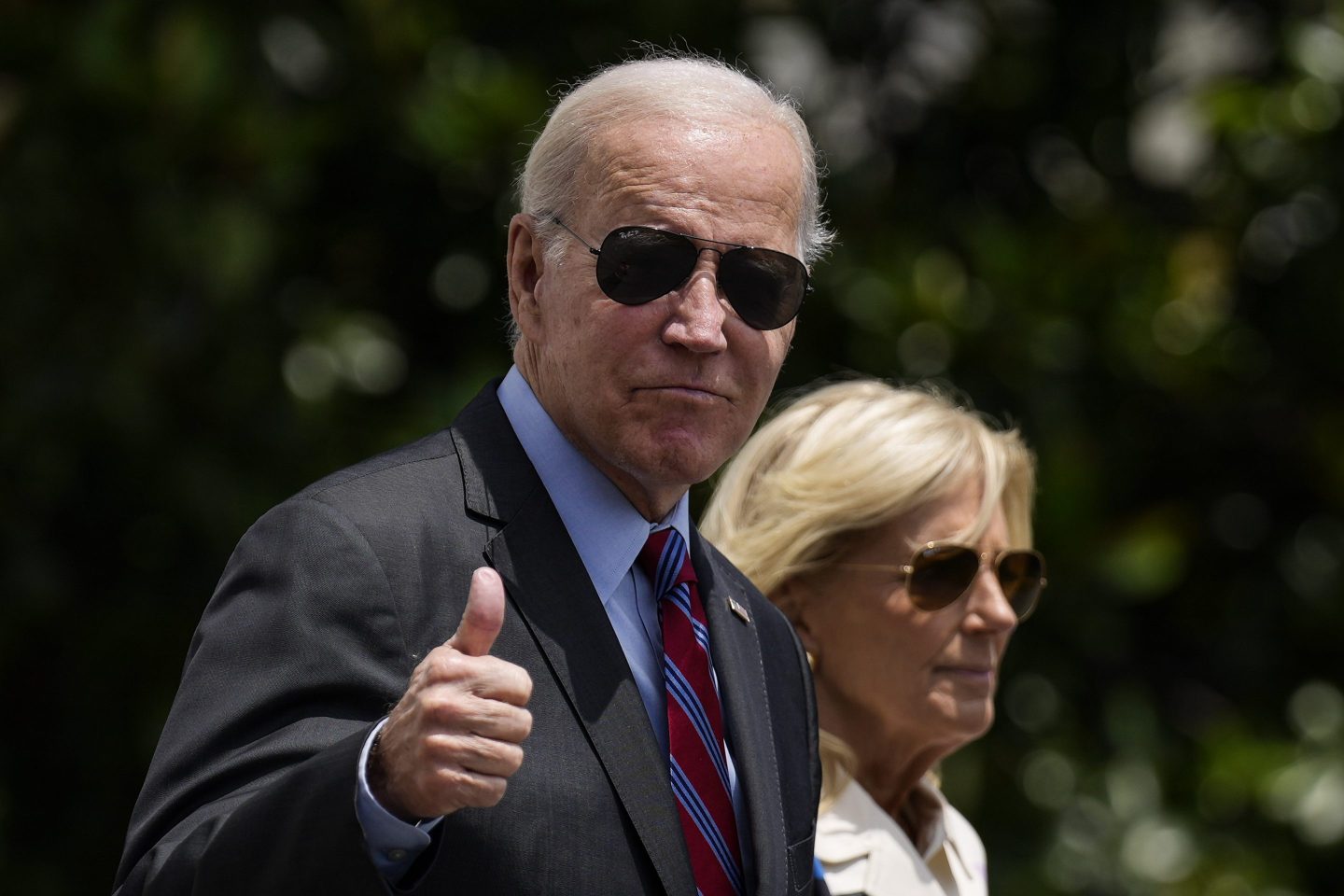 President Joe Biden gives a thumbs up as he walks with first lady Jill Biden to Marine One on the South Lawn of the White House on Jul. 14.