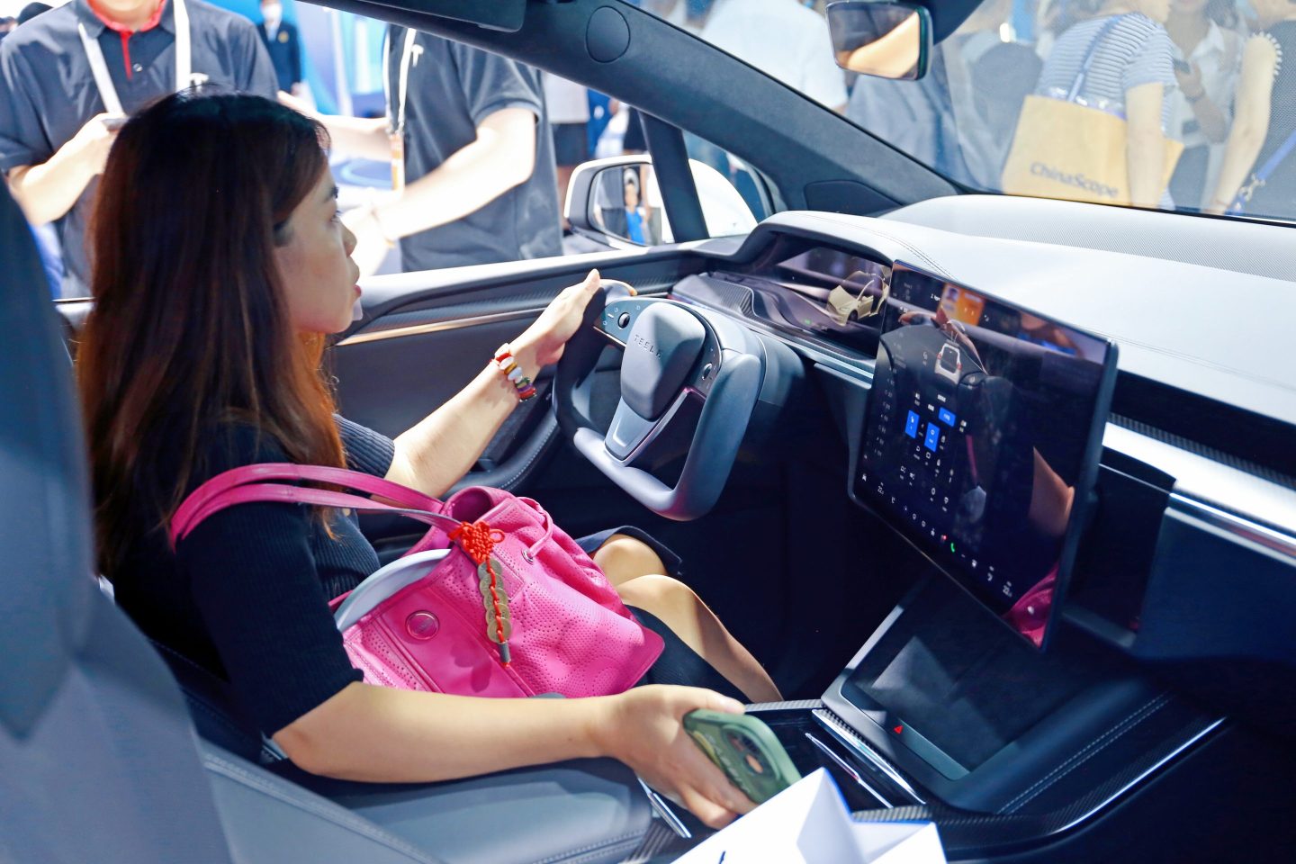 Visitors visit the Tesla booth at the World Artificial Intelligence Conference in Shanghai, July 6, 2023.