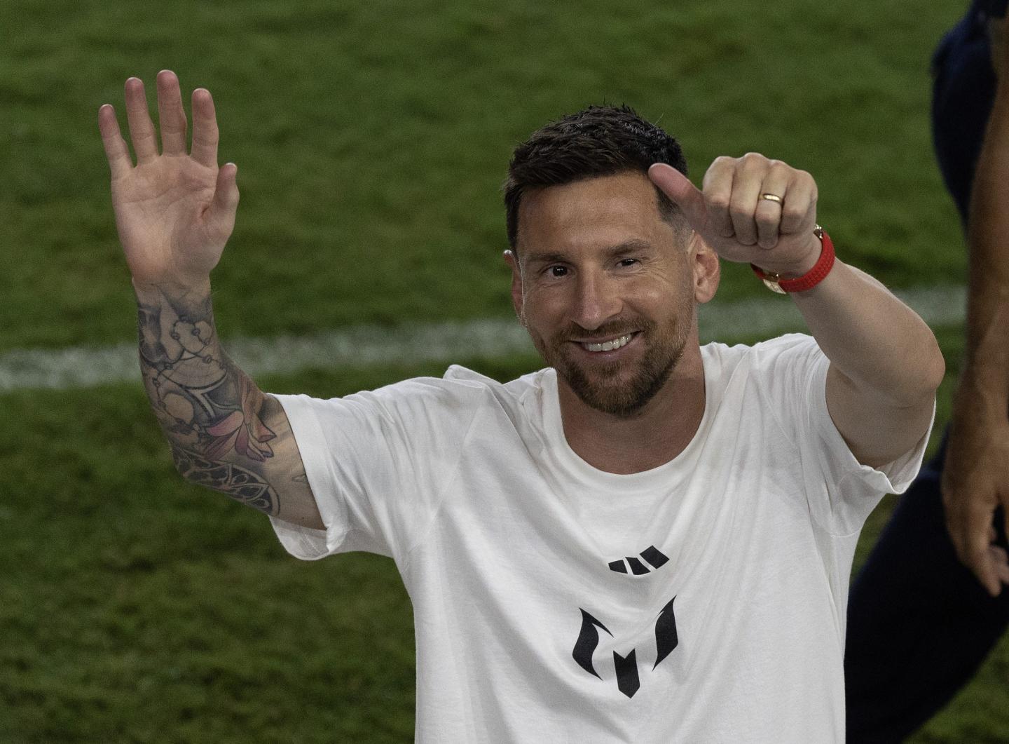 Lionel Messi smiles, as he is officially unveiled as an Inter Miami player.
