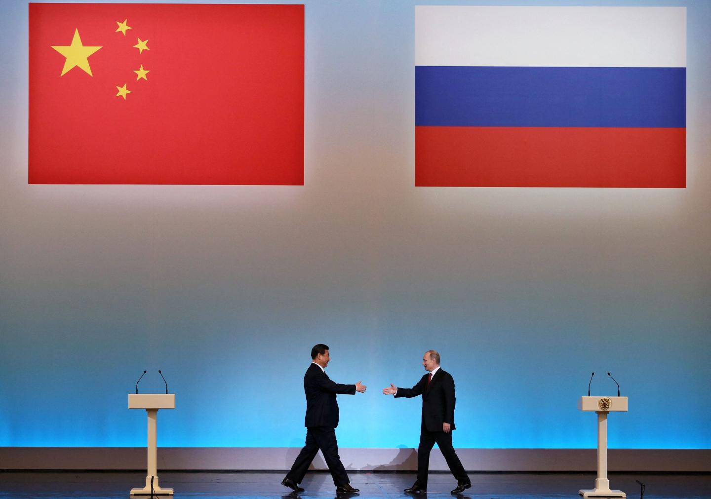 China's President Xi Jinping is welcomed by his Russian counterpart Vladimir Putin during the opening ceremony of "The Year of Chinese Tourism in Russia"