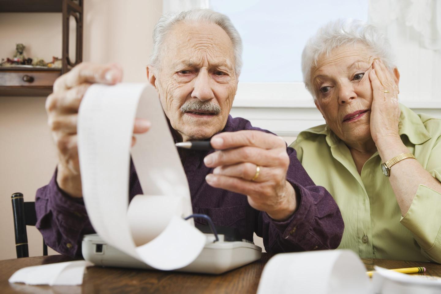 senior couple paying bills