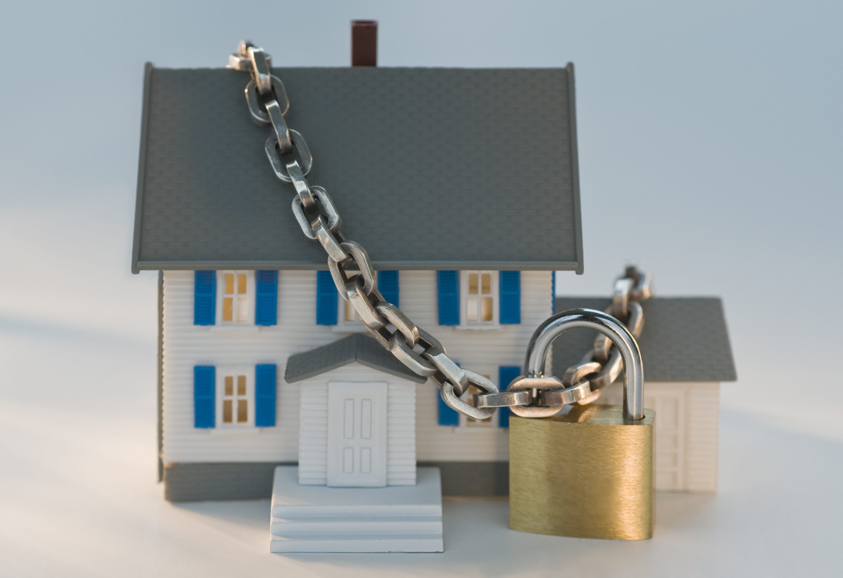 Model of a single-family home chained to a lock