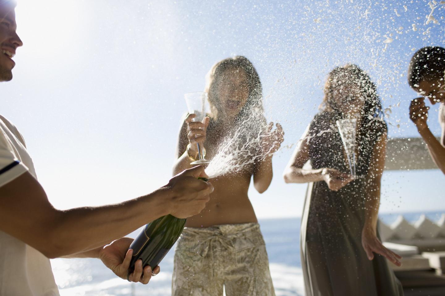 summer friends popping champagne