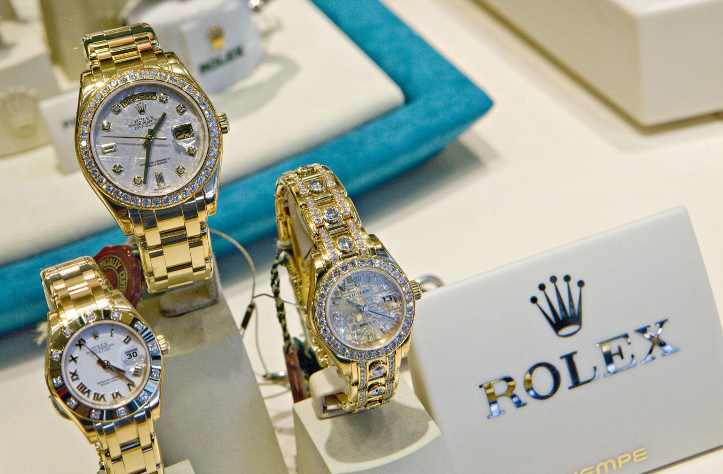 Three Rolex watches featured in a display case