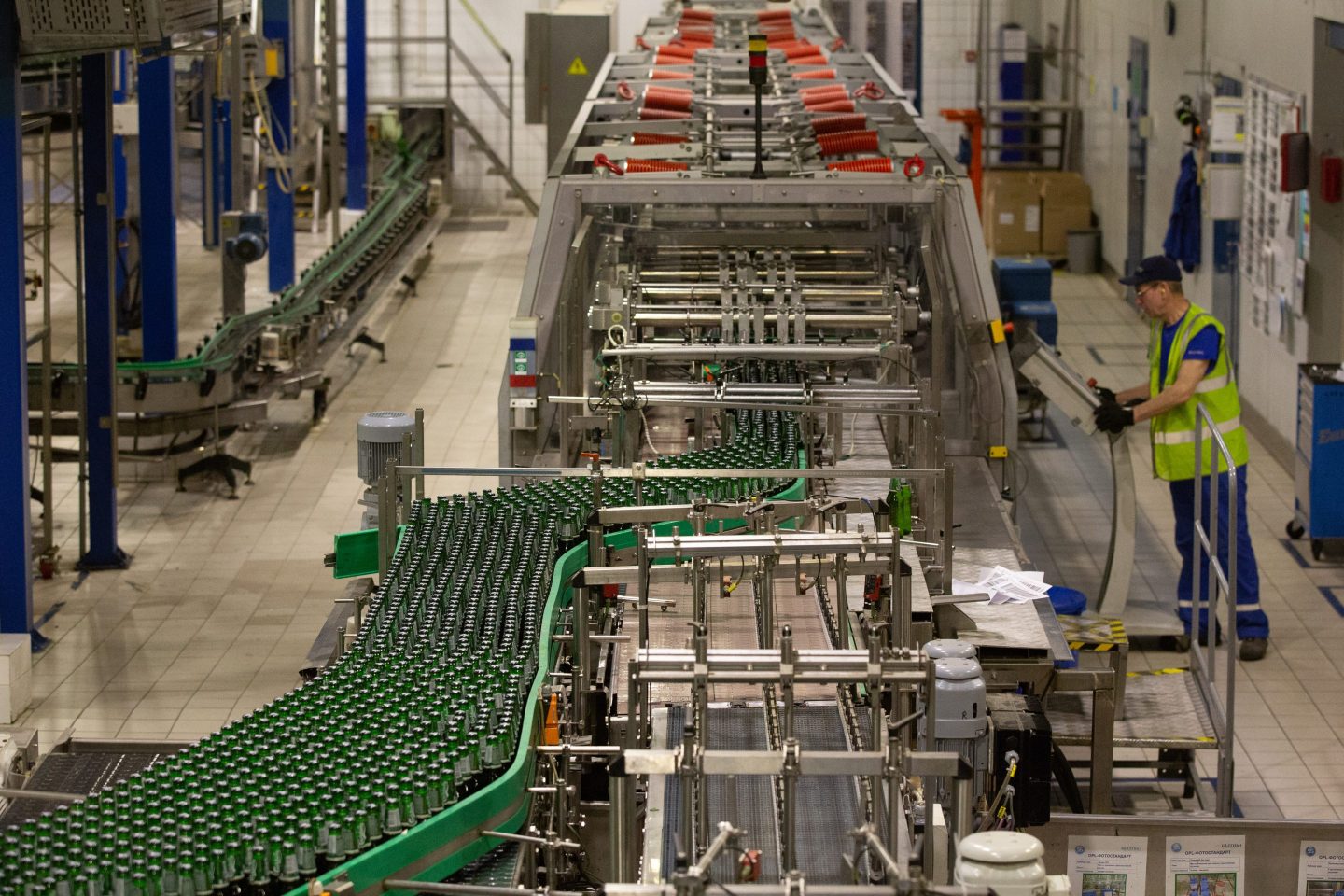 Green bottles of Carlsberg beer move along the production line at the Baltika Breweries plant, operated by Carlsberg, in Saint Petersburg, Russia, on May 10, 2018.