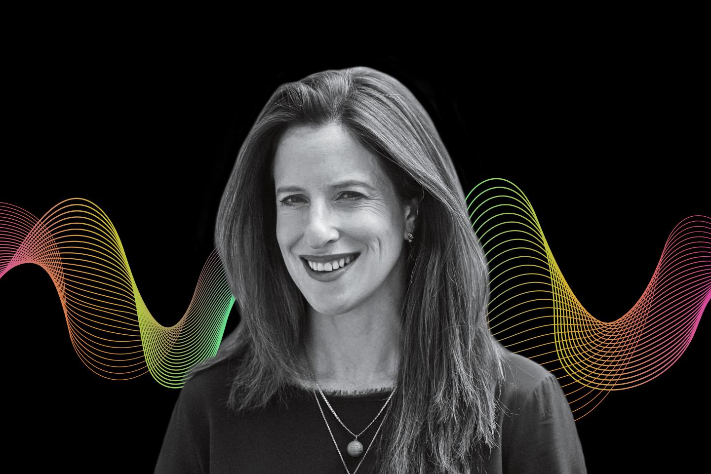woman smiling in front of a black background