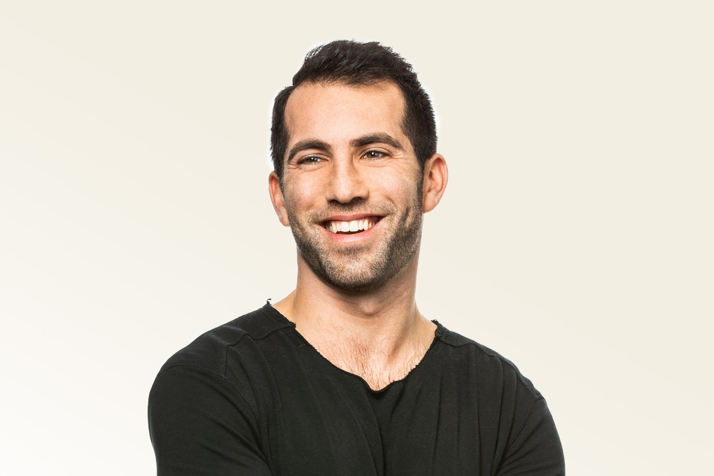 Man smiling wearing black v-neck t-shirt