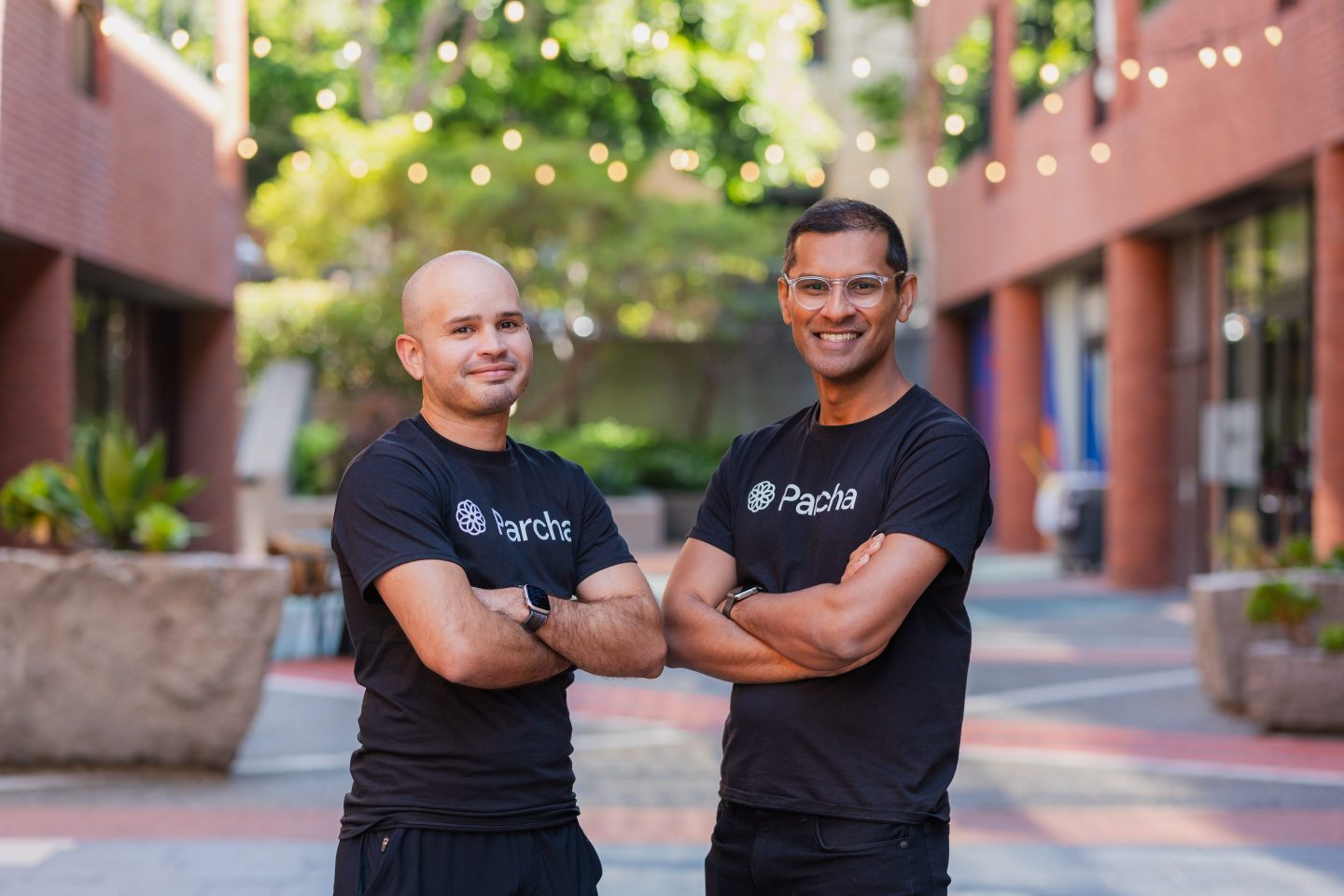 Two men wearing black t-shirts and smiling