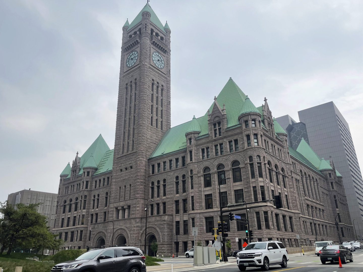 Cars drive past Minneapolis City Hall, June 28, 2023.
