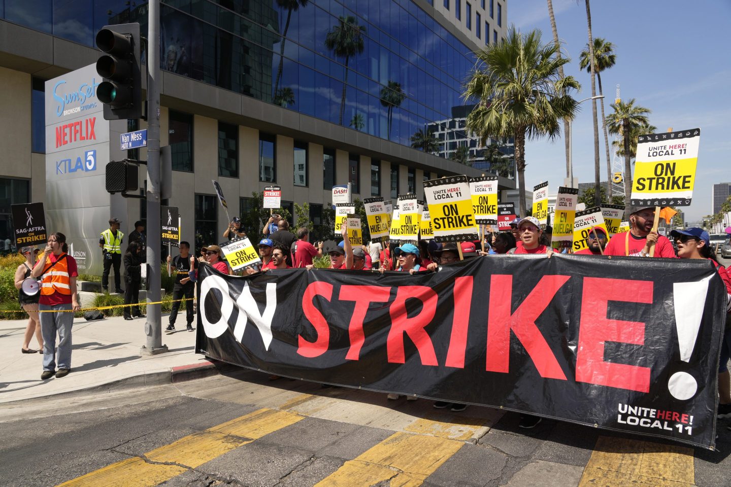 Striking hotel workers from Unite Here Local 11 join the picketing actors of SAG-AFTRA, and writers of the WGA, outside Netflix studios on July 21, 2023, in Los Angeles. Some Democrats in the California legislature want to make striking workers eligible for unemployment benefits.
