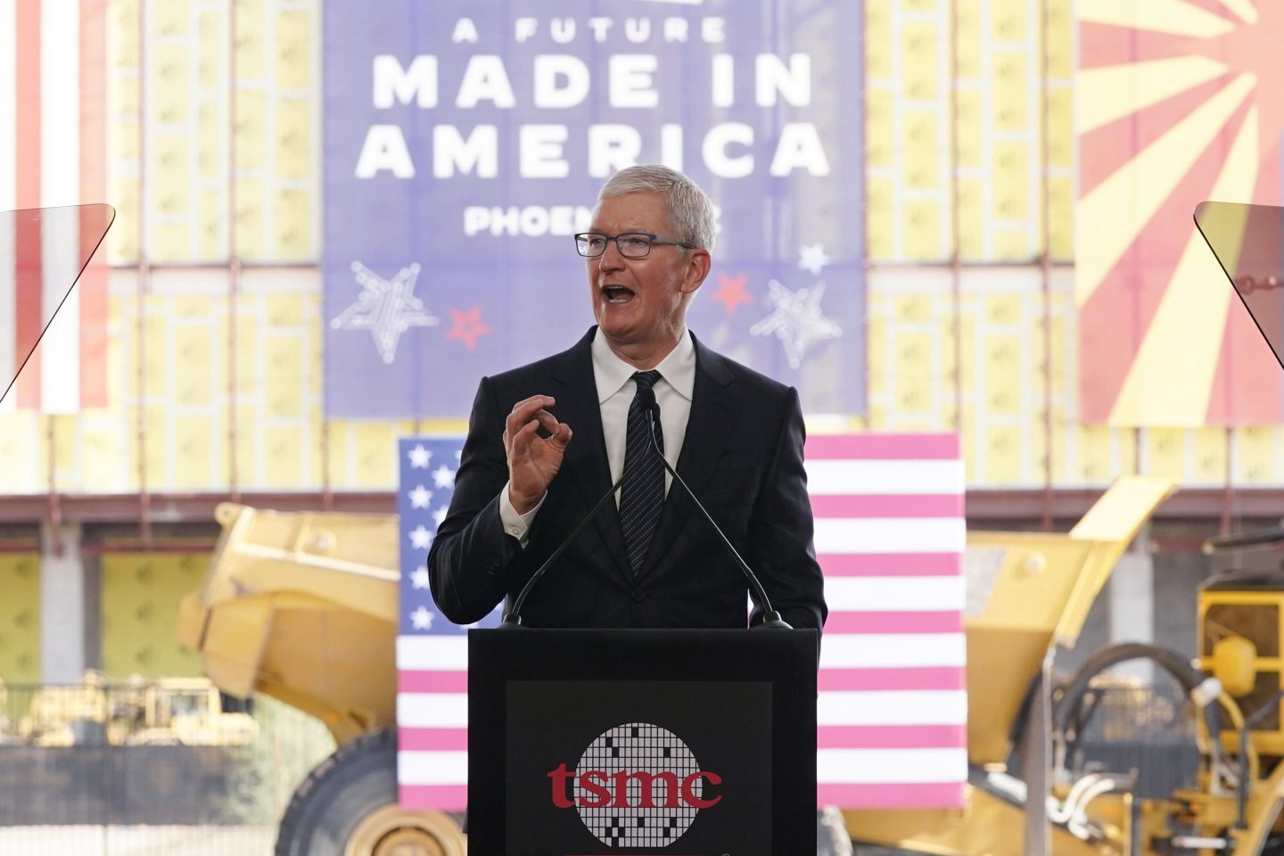 Apple CEO Tim Cook speaks at the Taiwan Semiconductor Manufacturing Company facility under construction in Phoenix last December. Multinational corporations are seeking to produce more items in the U.S. Apple will use chips made at the facility.