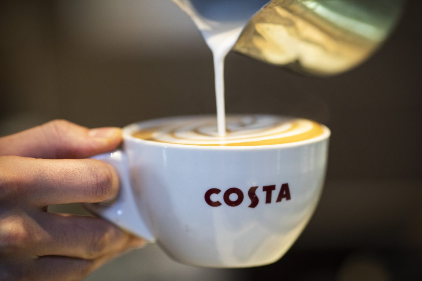 A Latte is poured into a branded Costa Coffee mug