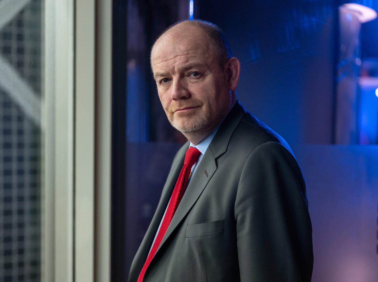 Newly appointed CNN CEO Mark Thompson stands next to a window.