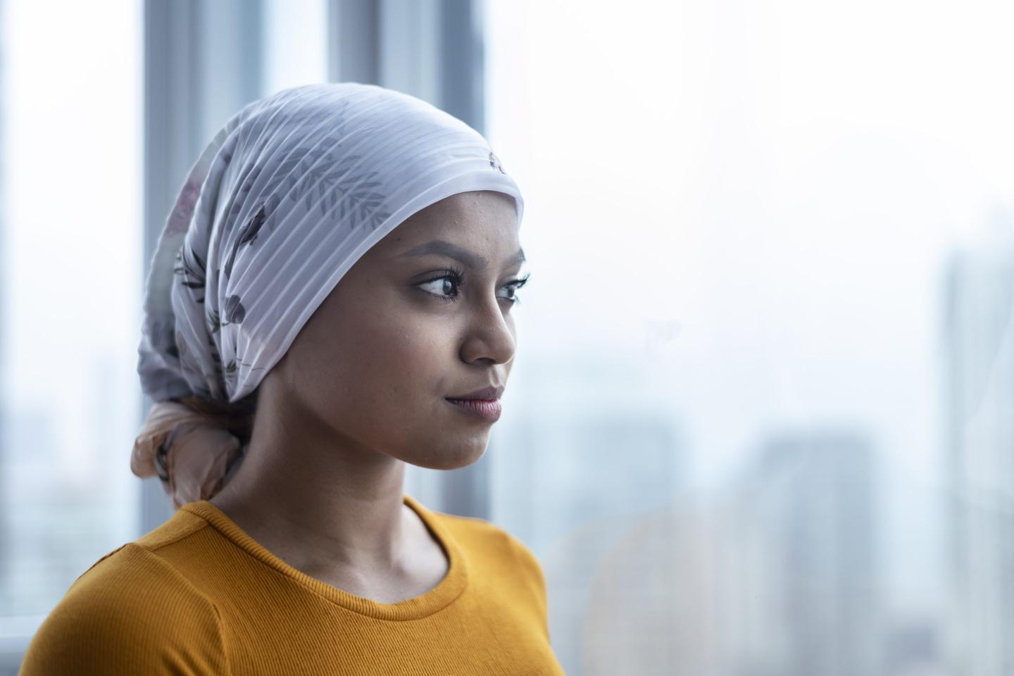 A woman with cancer wears a bandana.