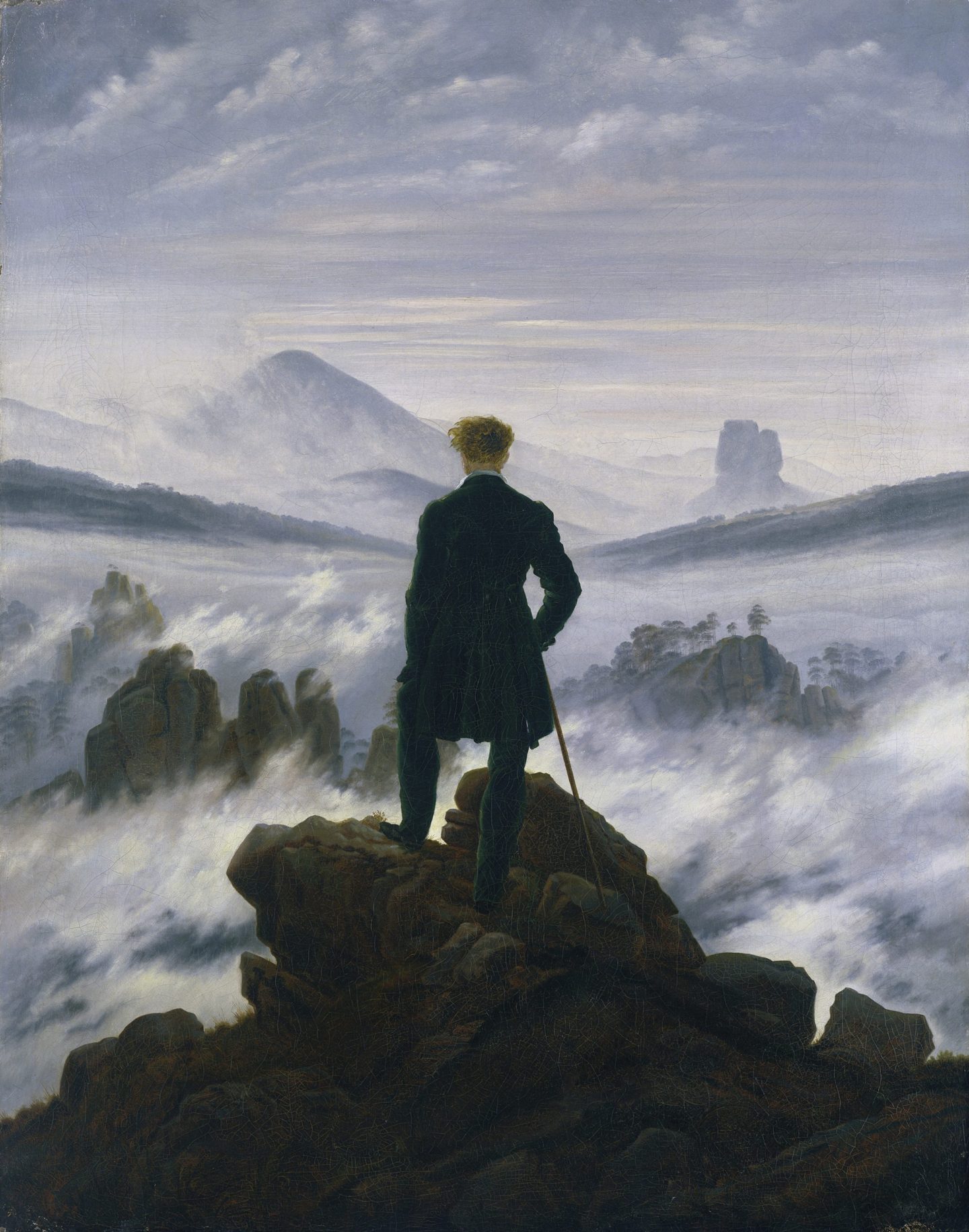 A painting depicts a man standing on a cliff as he looks down on a landscape enshrouded in thick fog