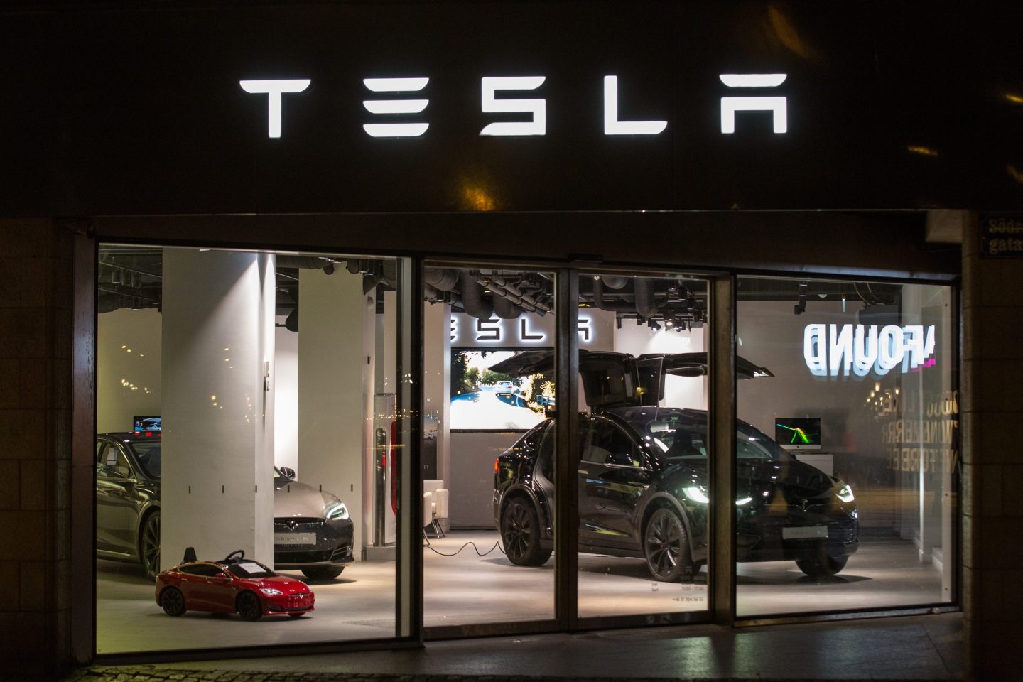 black car in Tesla store window