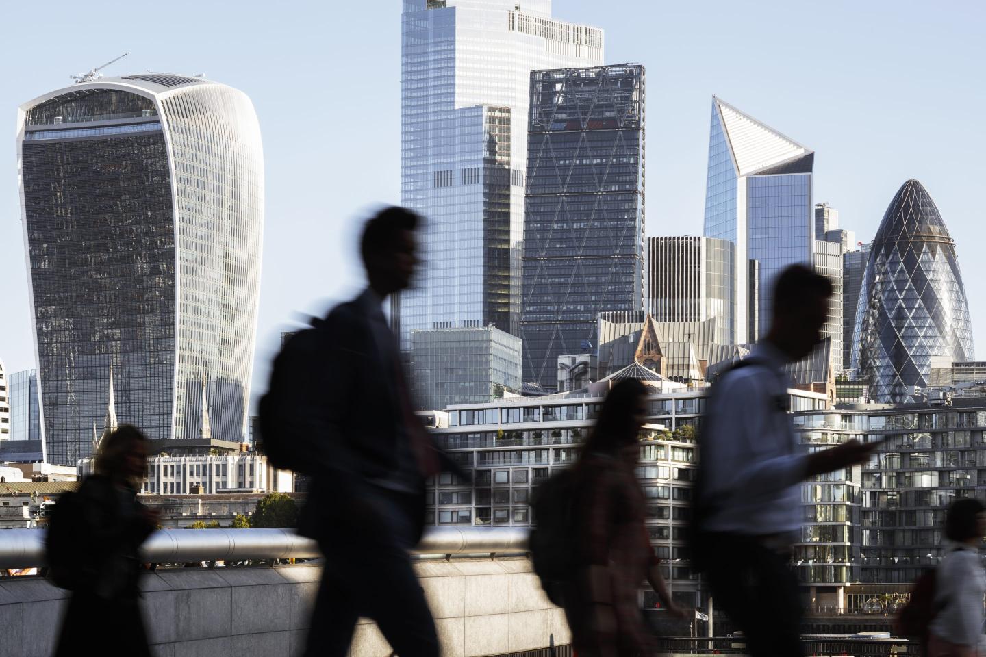 People walking against tall buildings in London