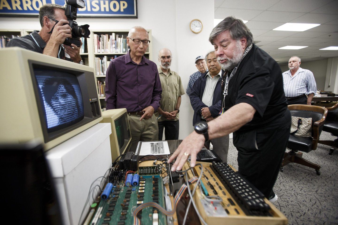 An Apple-1 computer signed by Apple cofounder Steve Wozniak (right) is up for auction.