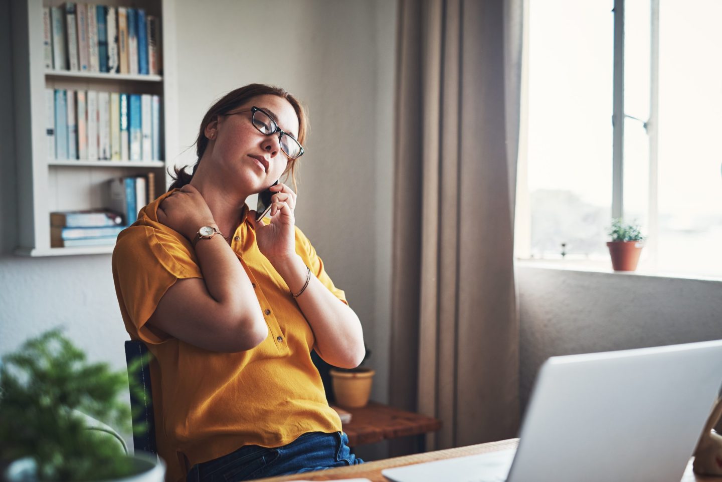 Worker looking stressed as she works from home