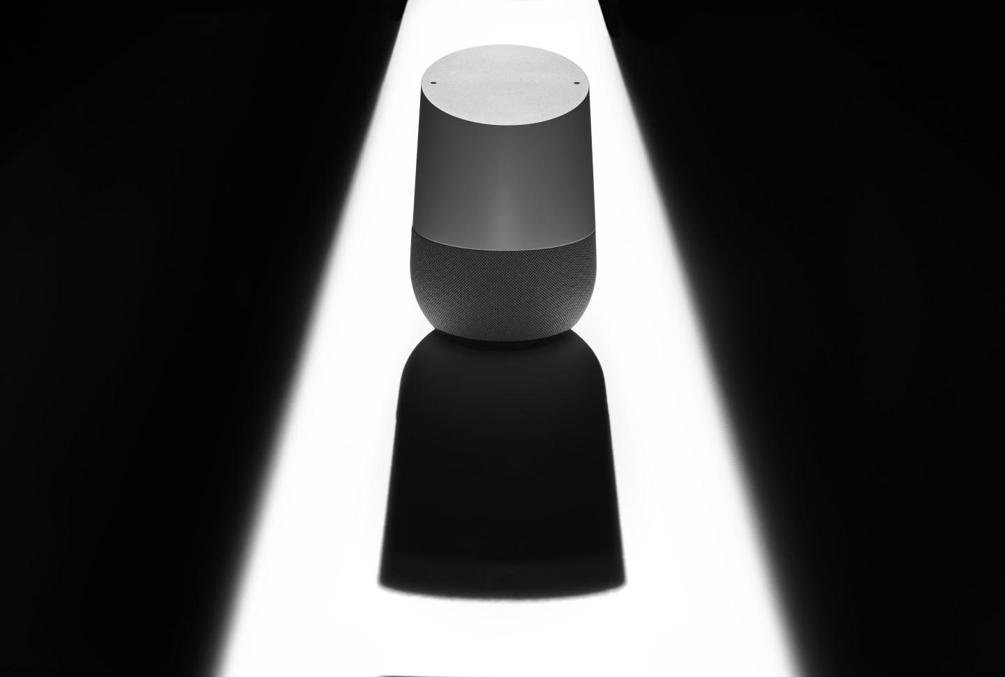 A Google Home smart speaker casting a sinister shadow, to represent issues of privacy and security, taken on December 12, 2019.