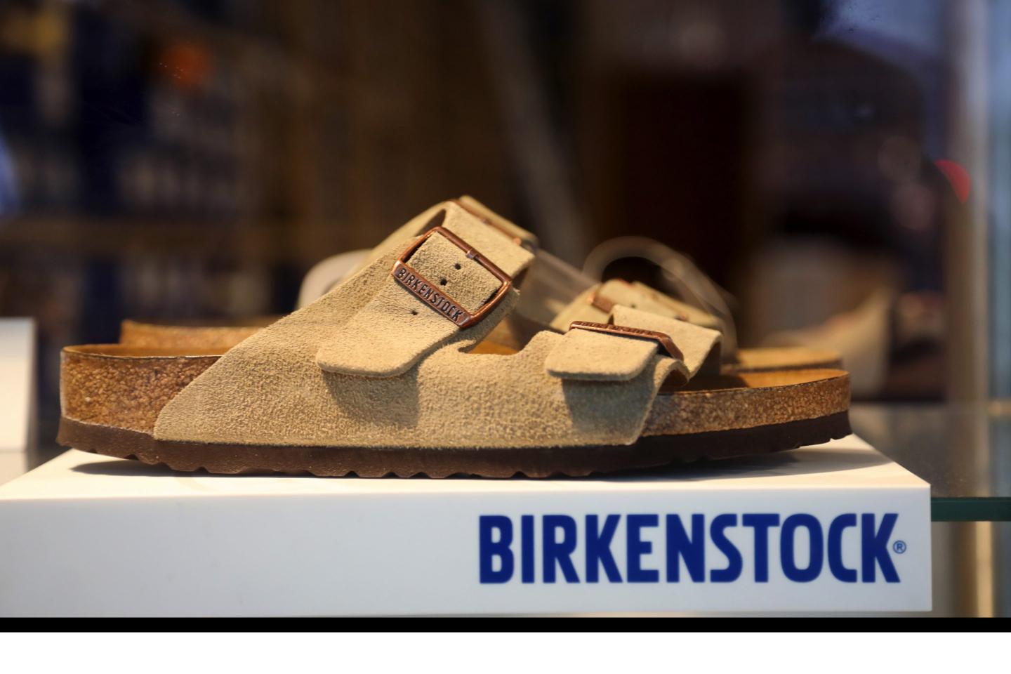 A sandal in the window display of a Birkenstock GmbH footwear store in Berlin, Germany