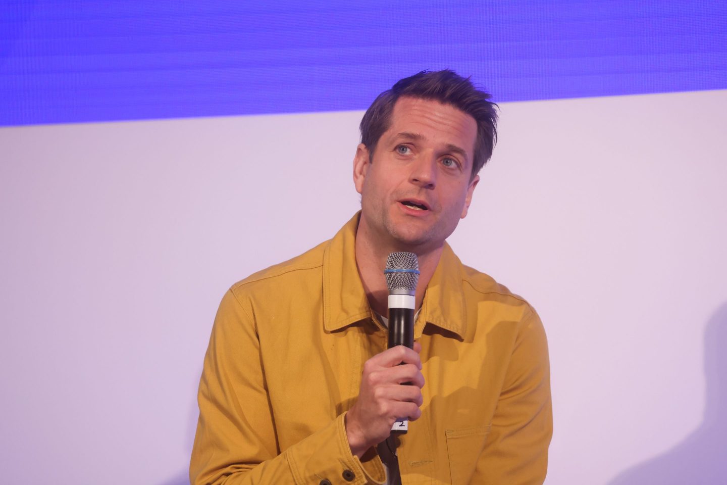 Klarna's CEO Sebastian Siemiatkowski holding a microphone