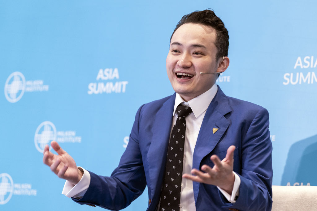 Man with microphone wearing a blue suit