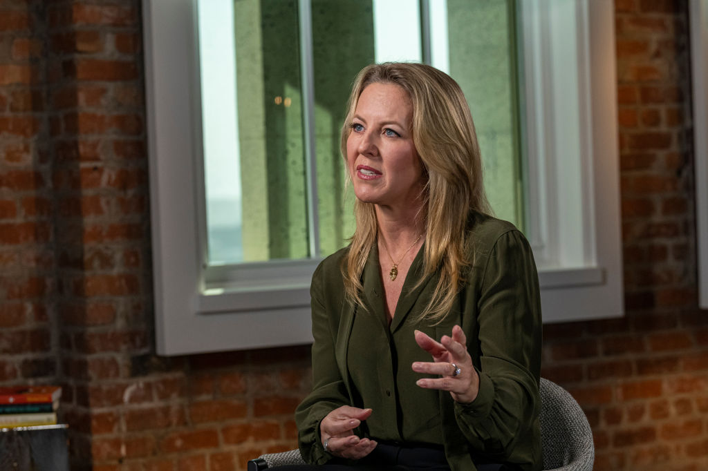 Blonde woman in green shirt speaking