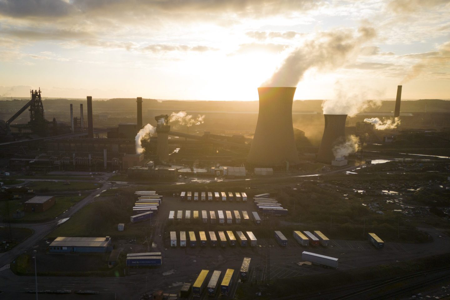 The sun rises behind chimneys at the British Steel Ltd. plant in Scunthorpe, U.K.