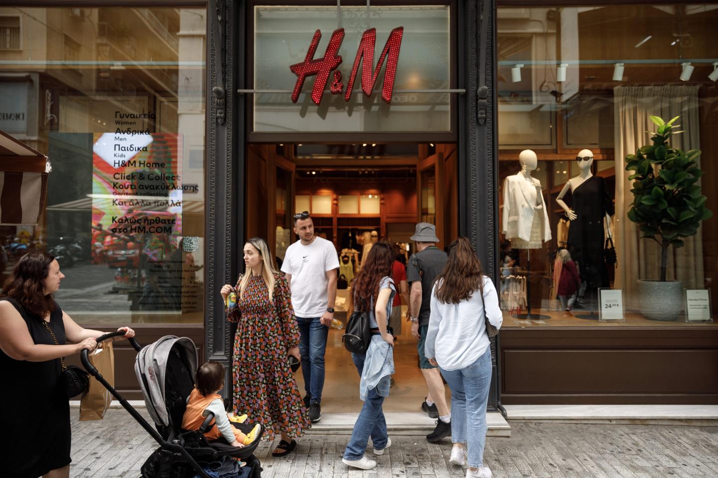 people walking in and out of an H&M store
