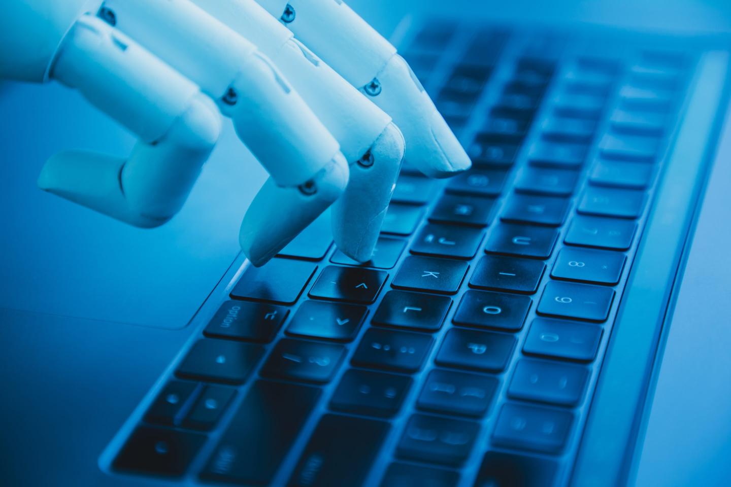 Robotic hand typing on laptop
