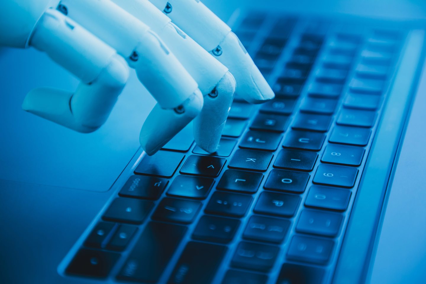 Robotic hand typing on laptop