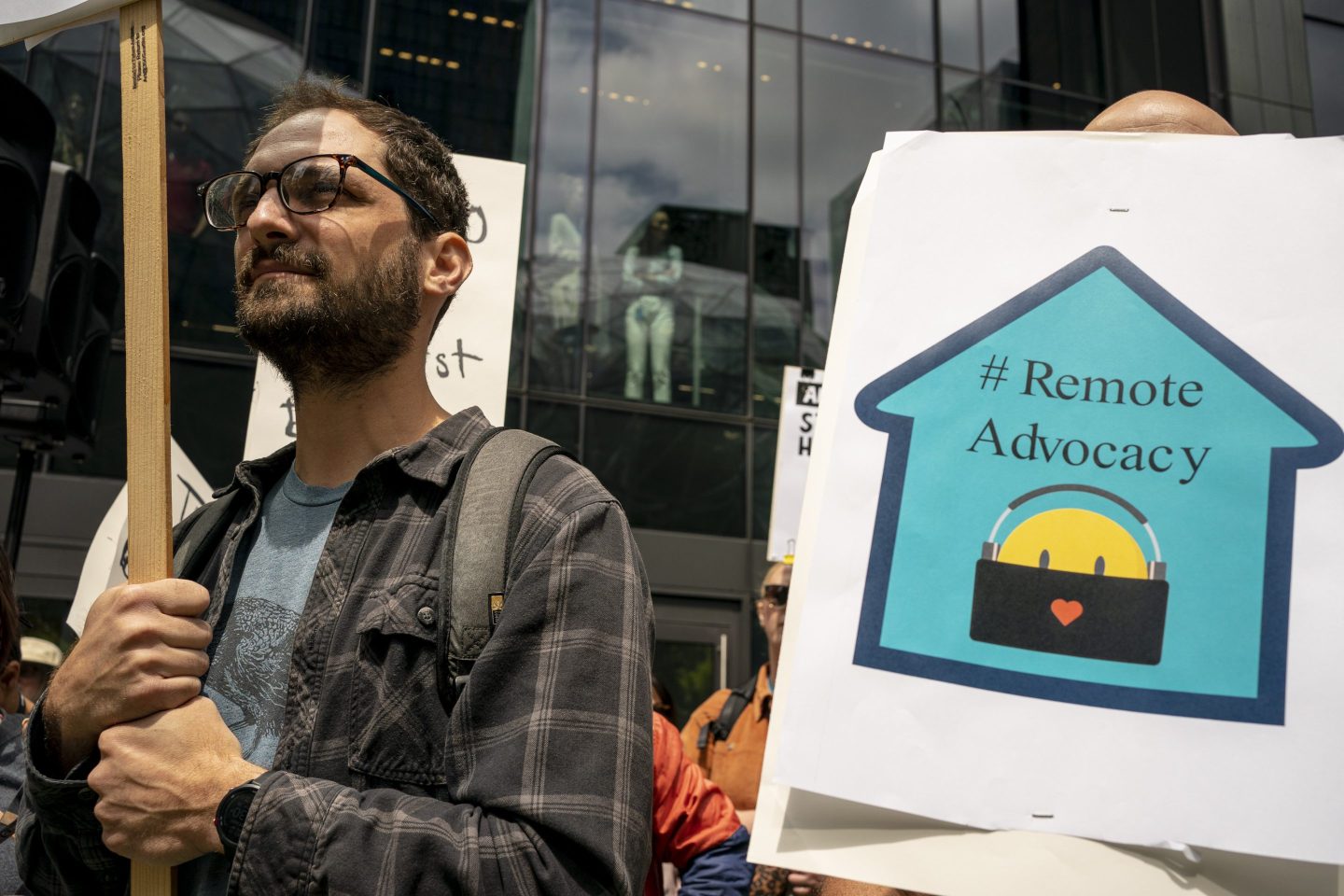 An Amazon employee holds up a sign at a protest in front of the company's headquarters.