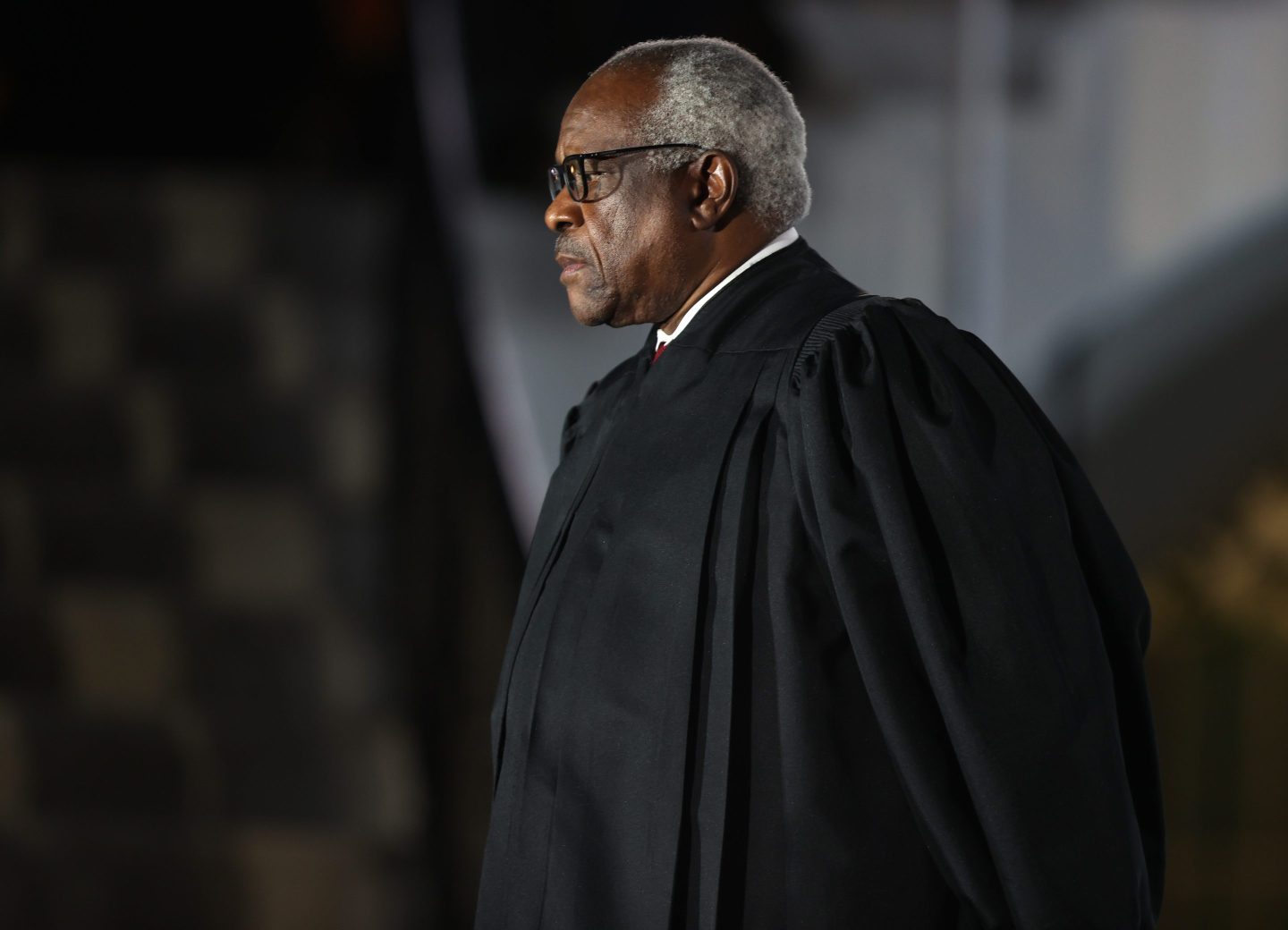 Supreme Court Justice Clarence Thomas standing in his black court robes