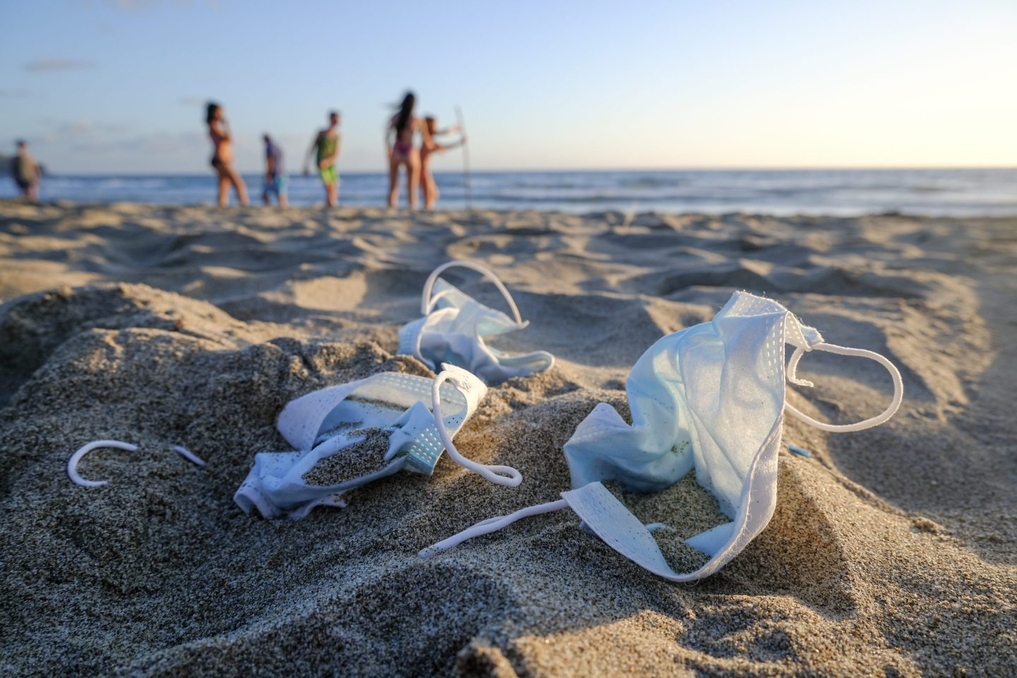 Photo of discarded masks on a beach