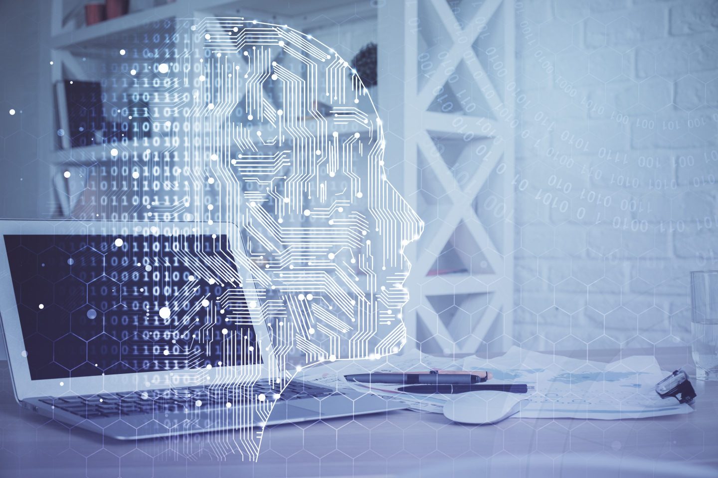 open laptop on a desk, with brain hologram superimposed on top