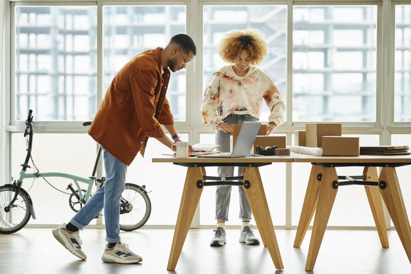 Male and female worker packing boxes