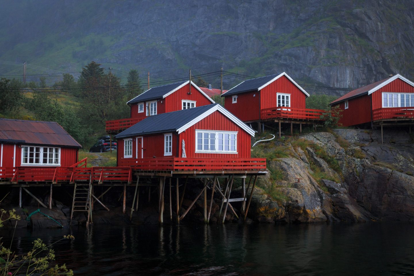 Scenic view of red cabins on a lake