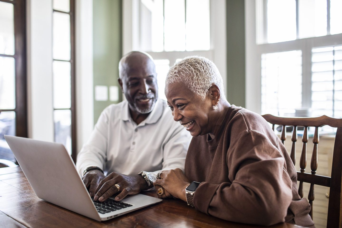 Senior couple using laptop at home