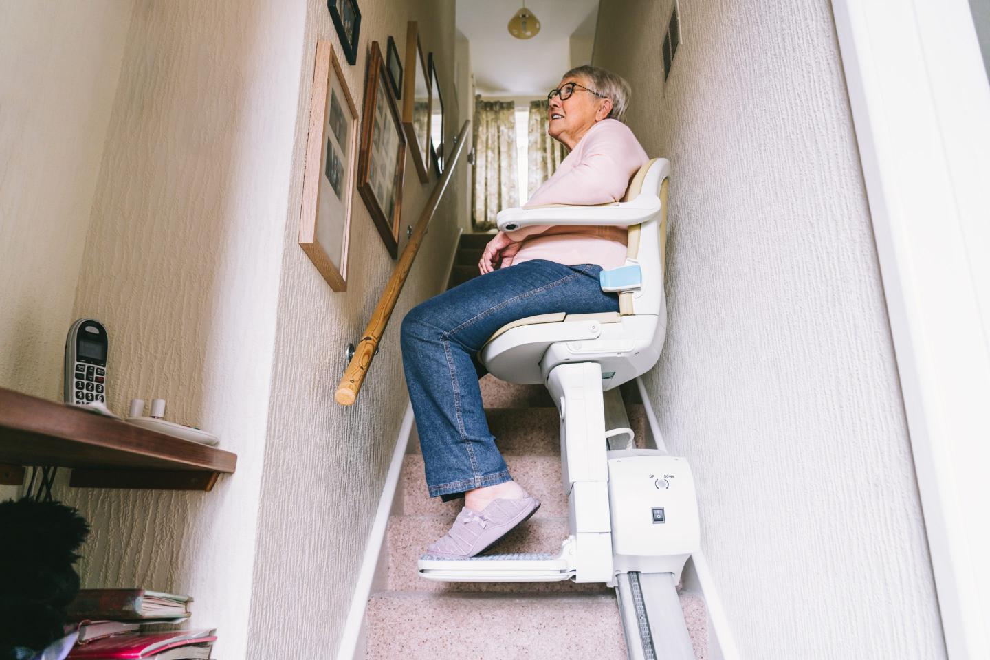 Senior woman using a stair lift
