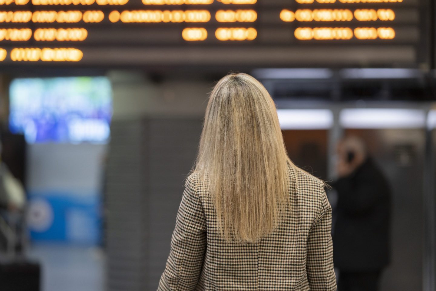 Woman in airport looking at schedule