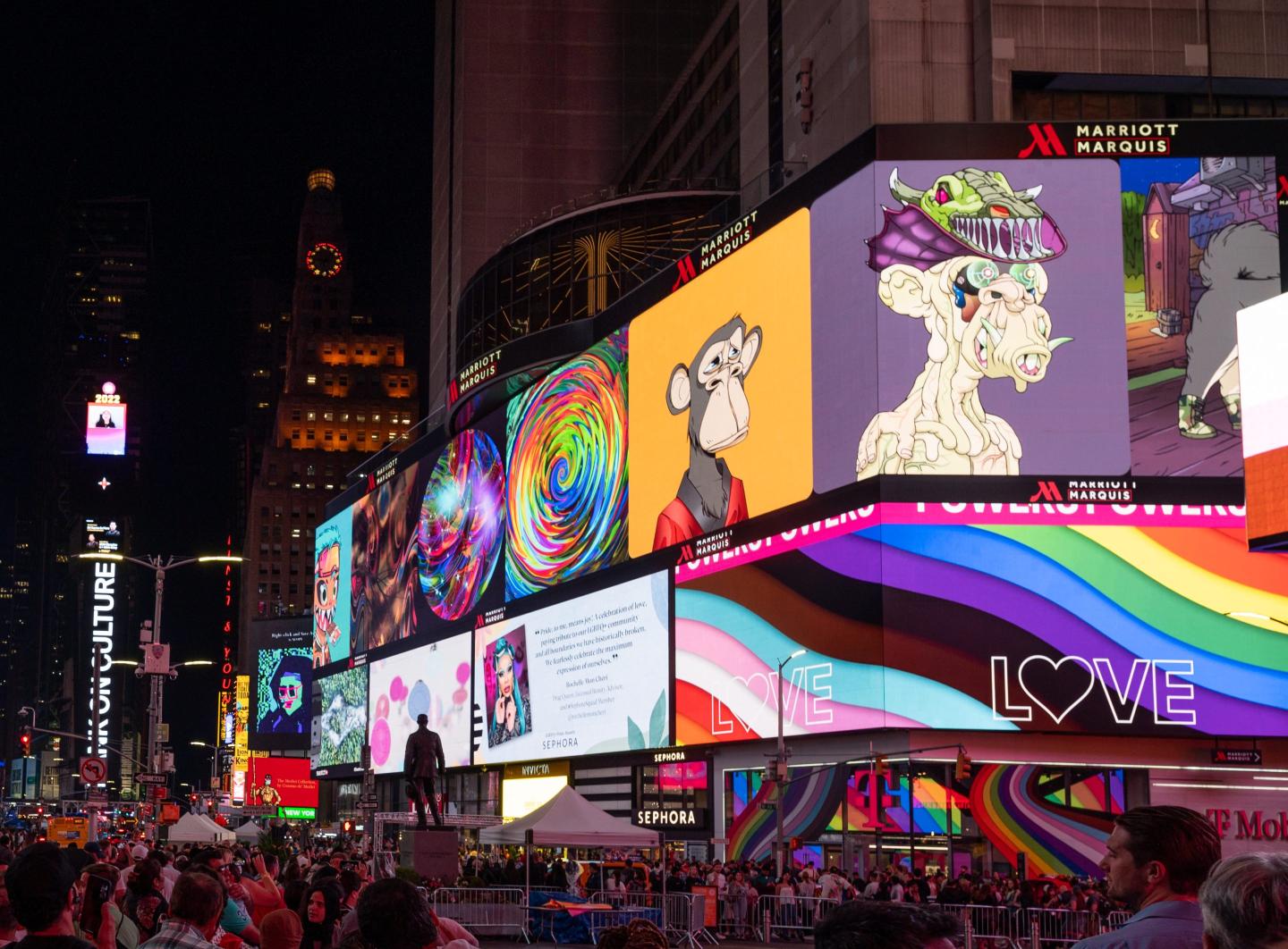 Times Square billboards display colorful images of an ape NFT