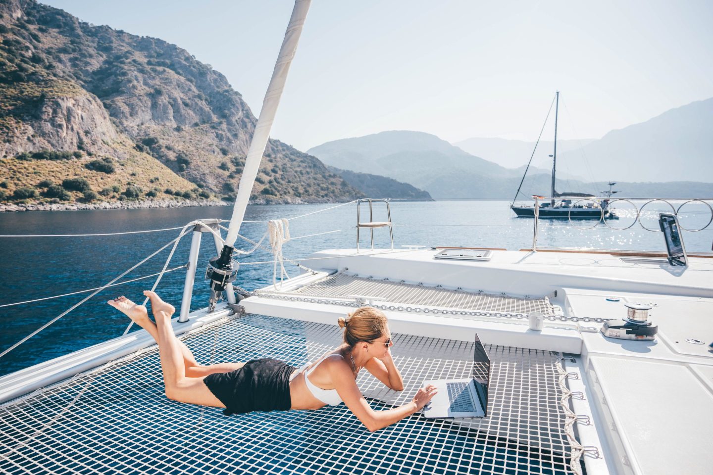 woman on yacht laptop