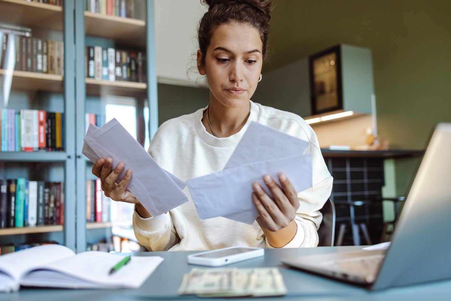 Woman sitting at a desk sorting paperwork