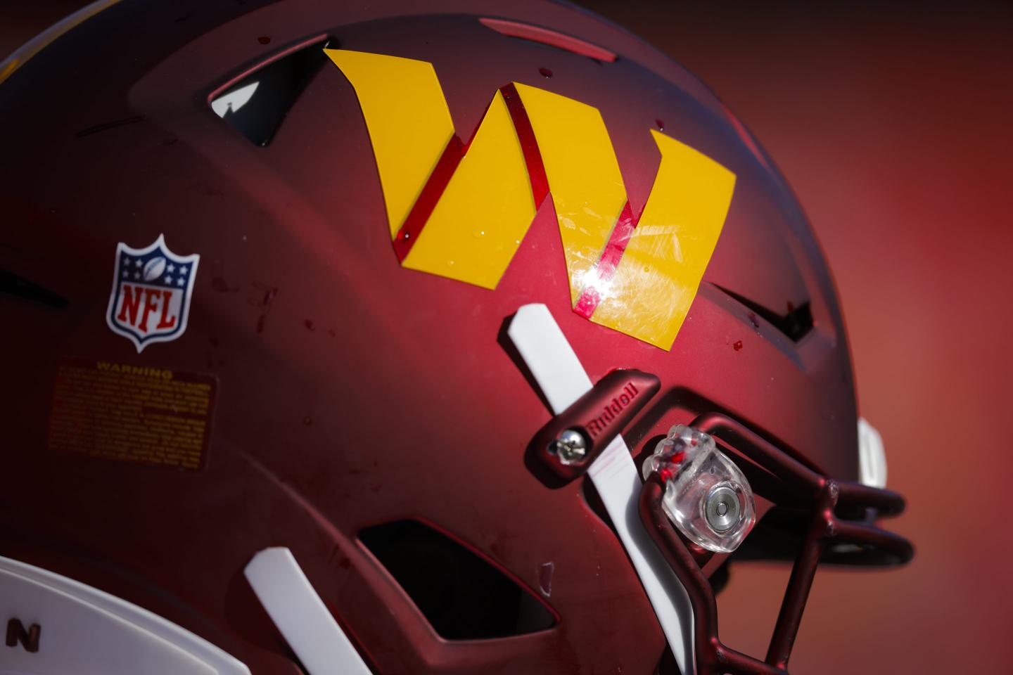 he gold Washington Commanders helmet logo on the burgundy helmet.