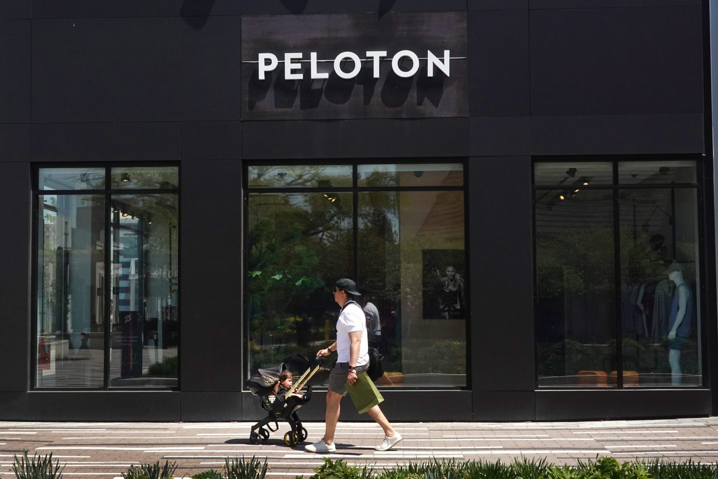 A shopper walks past a Peloton store in a shopping mall on May 11, 2023 in Oak Park, Illinois.