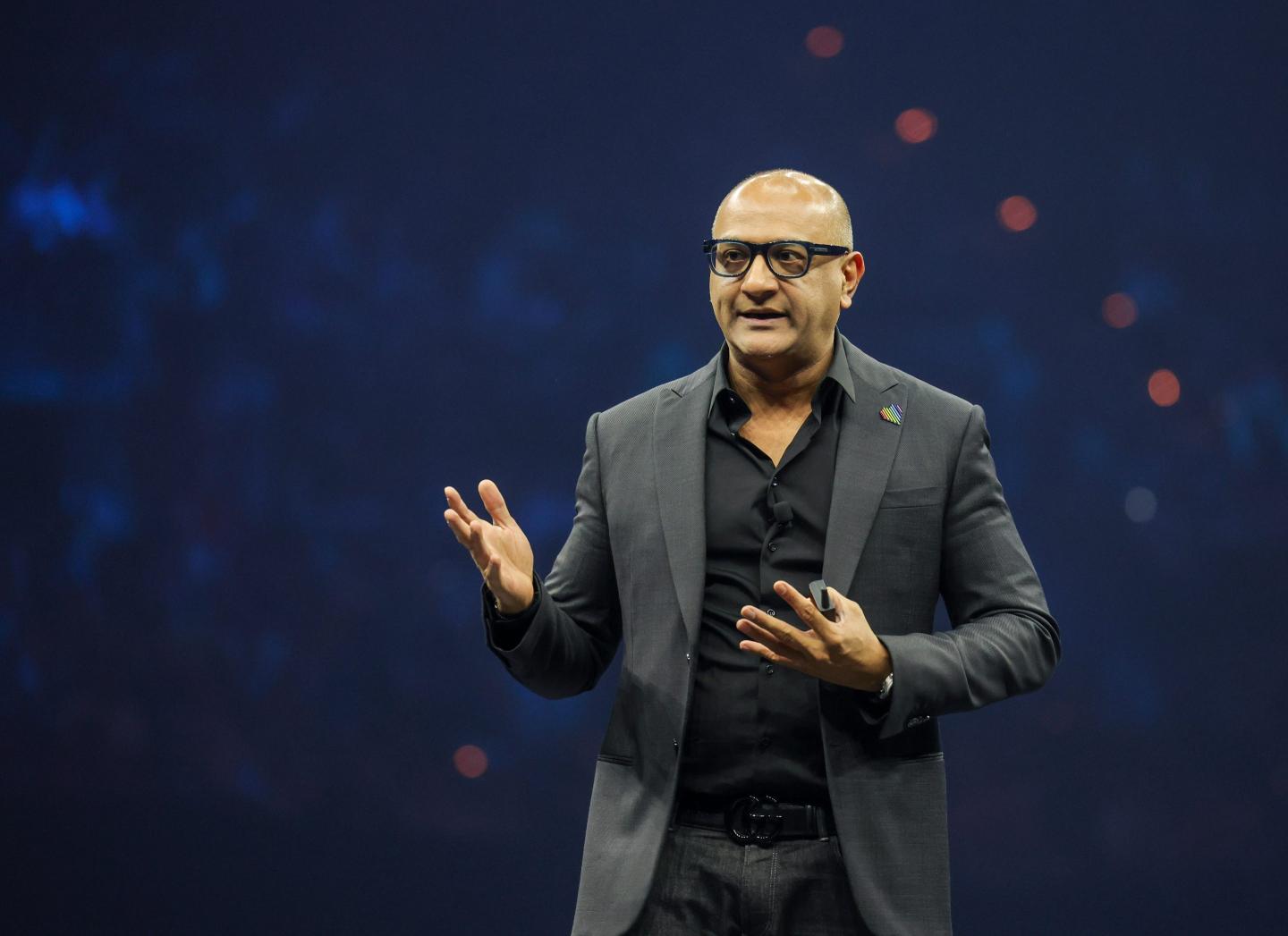 Man wearing a suit speaking onstage