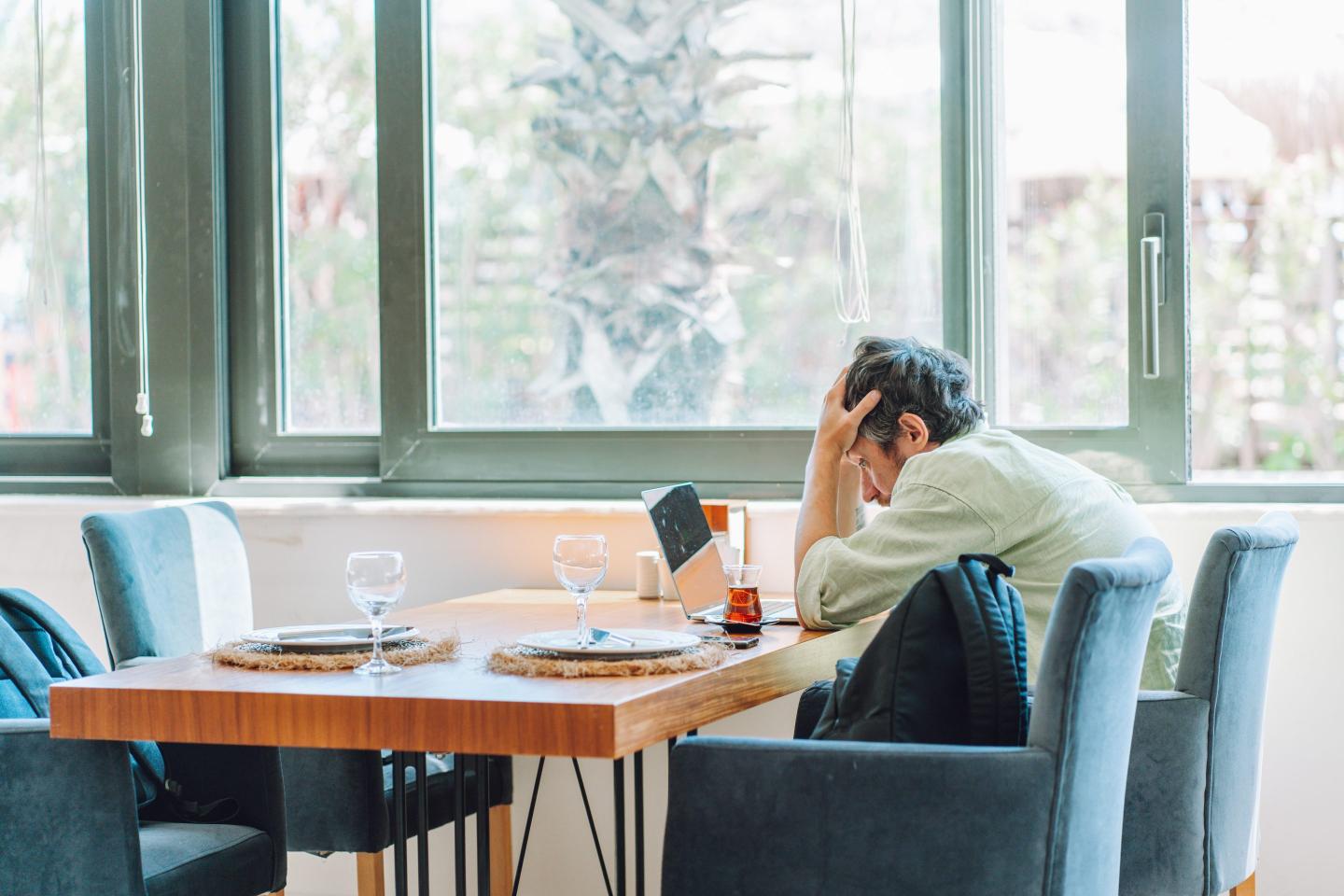 Distressed remote worker at laptop